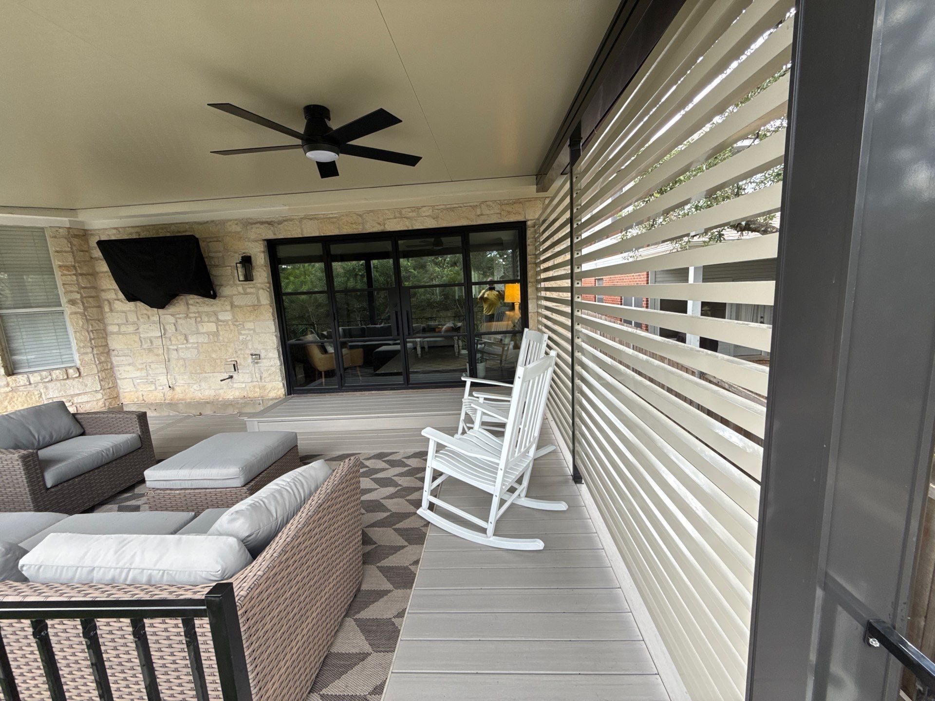 Covered patio outdoor living space with composite decking - Austin TX