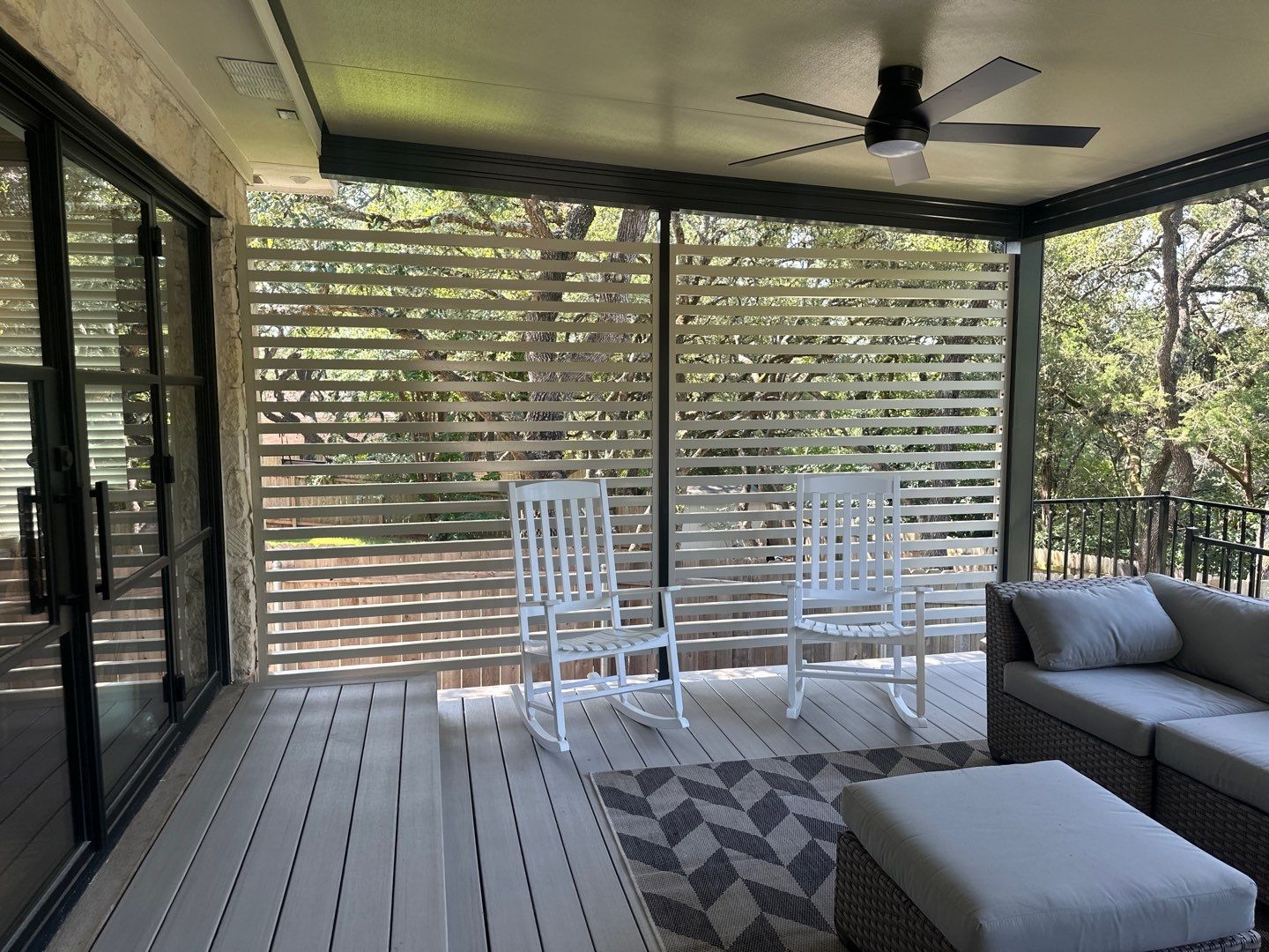 Covered patio with slatted privacy screen and outdoor furniture - Austin TX