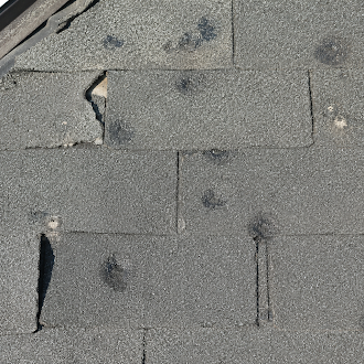 Hail impact damage on asphalt shingles - 1st Capital Certified Roofing Austin TX
